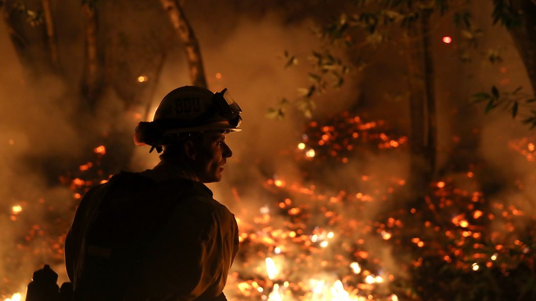 CalFire firefighter Trevor Smith monitors a firing operation while battling the Tubbs Fire on October 12, 2017 near Calistoga, California