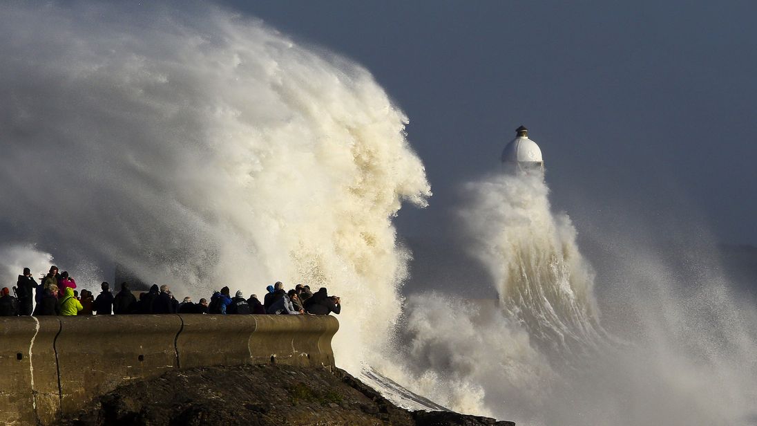 Huge waves strike the harbour wall and lighthouse at Porthcawl, south Wales