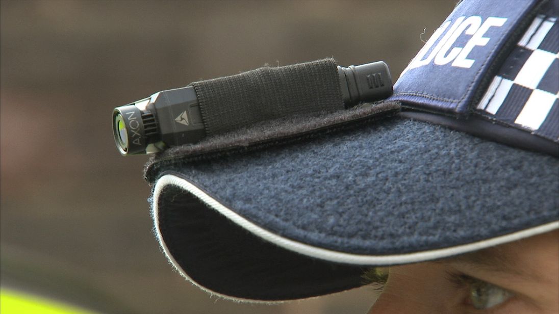 A police officer demonstrates a body-worn camera