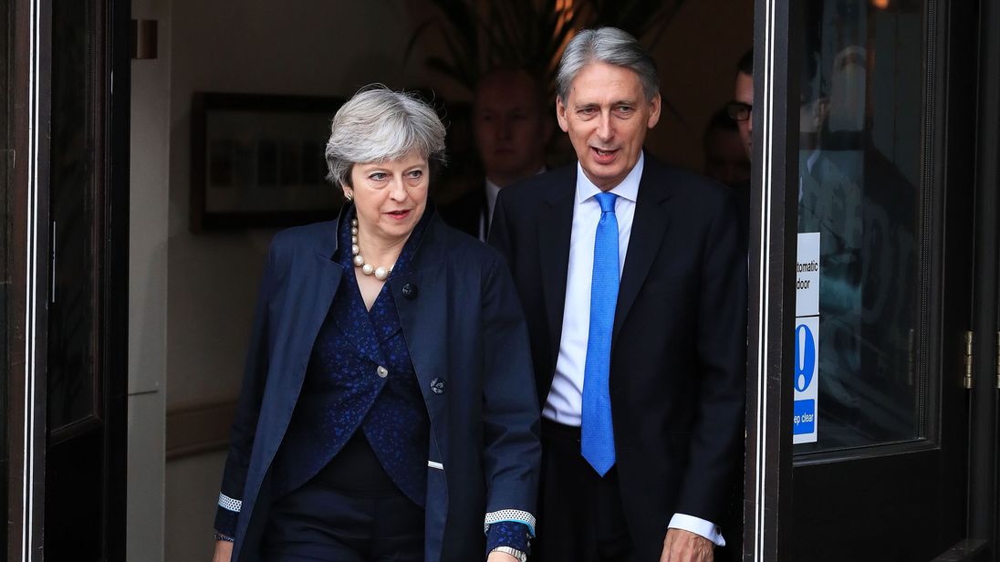 Theresa May and Philip Hammond leave the Midland Hotel on day two of the Tory party conference