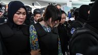 Vietnamese defendant Doan Thi Huong (C) is escorted by police personnel towards the low-cost carrier Kuala Lumpur International Airport 2 (KLIA2) in Sepang during a visit to the scene of the murder as part of the Shah Alam High Court trial process on October 24, 2017, for her alleged role in the assassination of Kim Jong-Nam