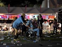 A man in a wheelchair is taken away from the Route 91 Harvest country music festival