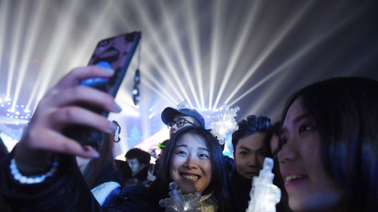 Chinese women pose for a selfie during New Year celebrations in Beijing on December 31, 2016