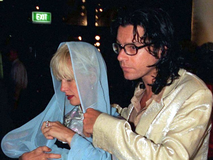 Michael Hutchence with Paula Yates, cradling two-month-old Tiger Lily