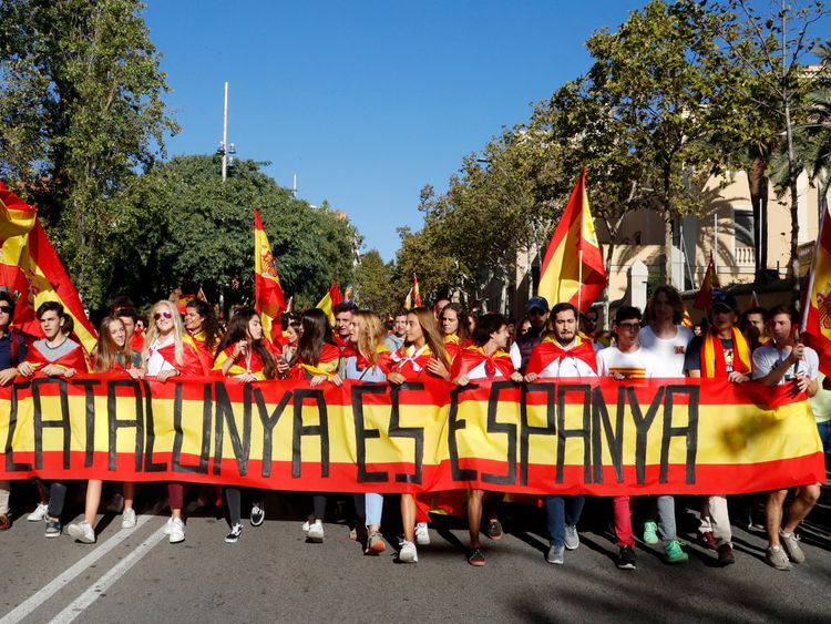 Catalans carrying Spanish flags during a pro-union demonstration in Barcelona