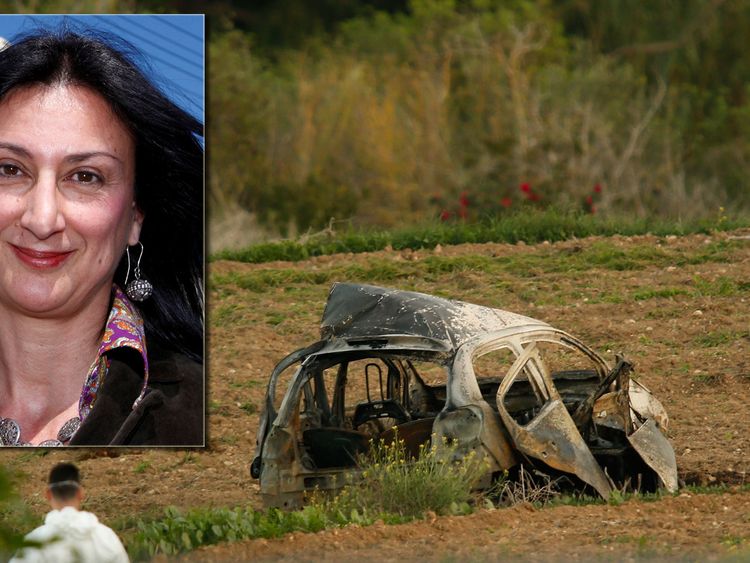 A forensics expert walks in a field after a powerful bomb blew up a car killing investigative journalist Daphne Caruana Galizia in Bidnija, Malta