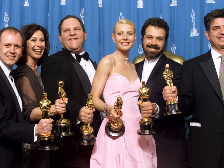 Gwyneth Paltrow celebrates the Oscar she won for Shakespeare in Love with the producers of the film, including Harvey Weinstein (3rd left)