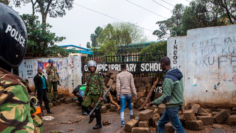 Opposition supporters clash with police after blocking a polling station at a school in Kibera, Nairobi