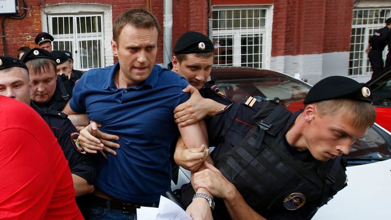 Policemen detain Russian opposition leader and anti-corruption blogger Alexei Navalny 