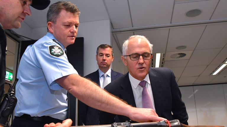 Australian Prime Minister Malcolm Turnbull surveys the gun haul