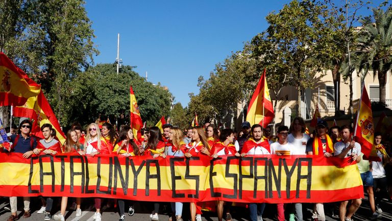 Catalans carrying Spanish flags during a pro-union demonstration in Barcelona