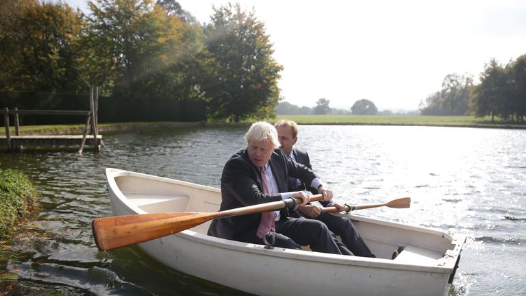 Boris Johnson (L) and Czech Republic's Deputy Foreign Minister Ivo Sramek (R) go out onto a boating lake in a rowing boat before attending a lunch meeting with other European foreign ministers at the British Foreign Secretary's official residence Chevening House