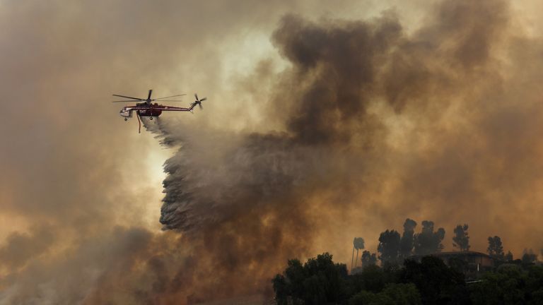 Helicopter drops water on California wildfires