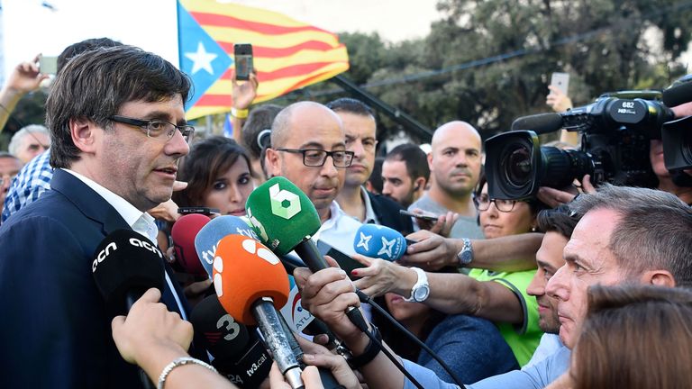 President of the Catalan Government Carles Puigdemont (L) answers to media after a pro-independence demonstration, on September 11, 2017 in Barcelona during the National Day of Catalonia