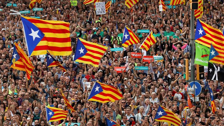 People wave Catalan separatist flags in Barcelona