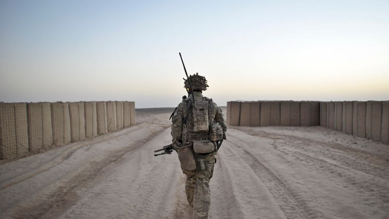 A soldier from the 1st Battalion Royal Regiment Fusiliers leaves the security of the camp walls to conduct a dawn foot patrol in the Nahr-e Saraj district, Helmand Province, Afghanistan after leaving base Sterga 2. PRESS ASSOCIATION Photo. Picture date: Saturday October, 5, 2013. See PA story DEFENCE Afghanistan. Photo credit should read: Ben Birchall/PA Wire