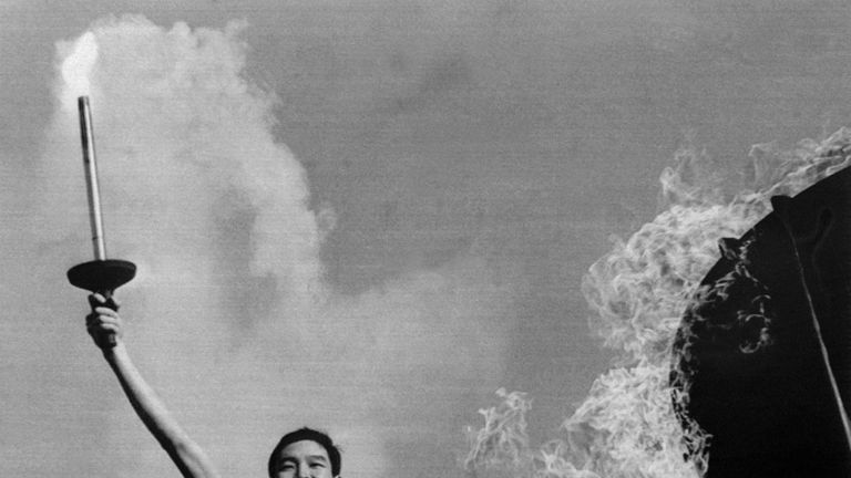 Yoshinori Sakai lights the Olympic flame at the opening of the Olympic Games in 1964