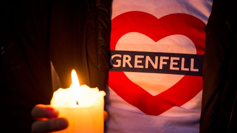 People take part in a silent march for Grenfell Tower fire victims in west London