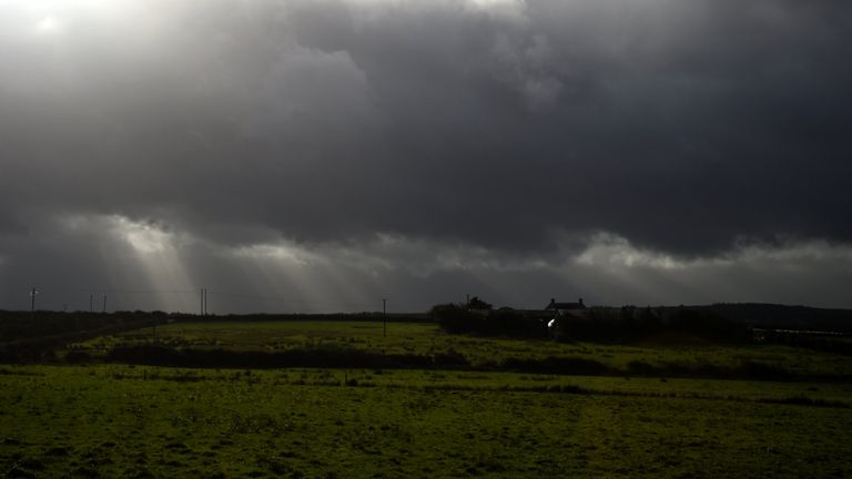 Rays of sunlight shine through dark clouds as storm Ophelia hits the County Clare town of Doonbeg, Ireland