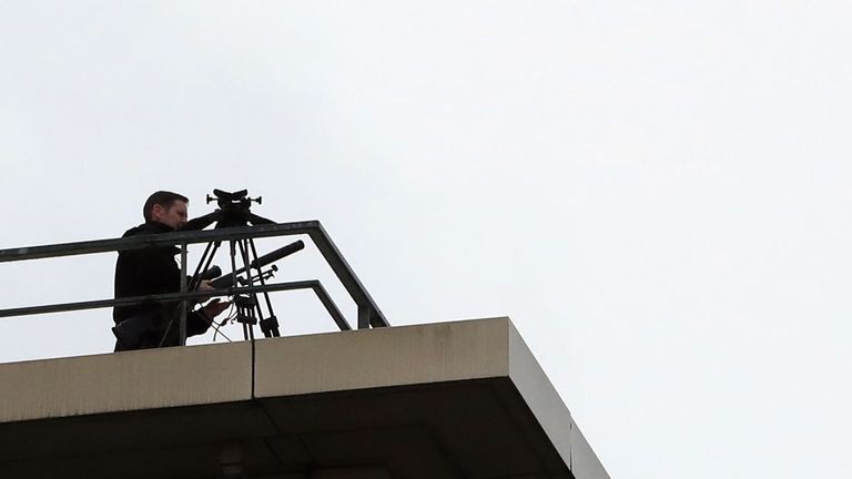 Police marksmen keep watch over delegates