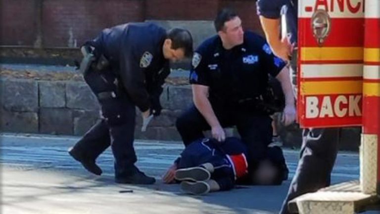 NYPD officers with the suspect moments after he was shot