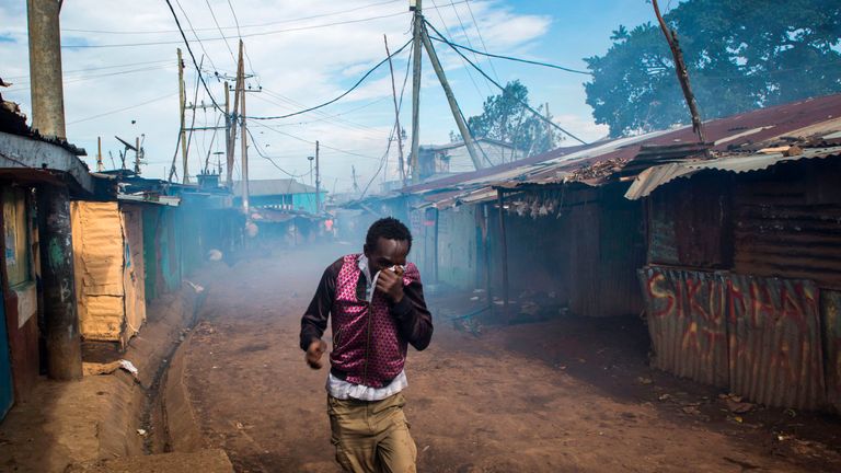 n opposition supporter reacts as Kenyan police spray teargas during clashes at the Kibera slum in Nairobi on October 26, 2017, after trying to block Olympic Primary polling station during Kenya&#39;s re-election voting. At least three people were shot dead on October 26 and more than 30 wounded as opposition protesters clashed with police during Kenya&#39;s presidential re-run, police and hospital sources said. / AFP PHOTO / Patrick Meinhardt (Photo credit should read PATRICK MEINHARDT/AFP/Getty Images)