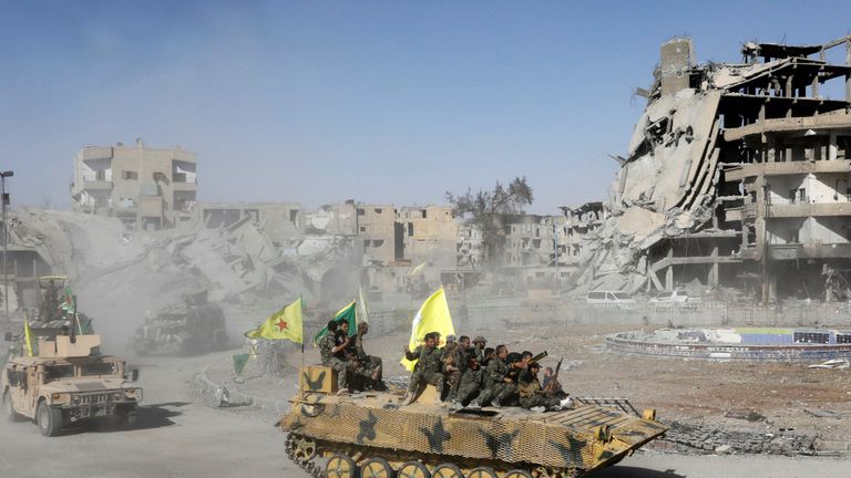 SDF fighters celebrate victory in Raqqa
