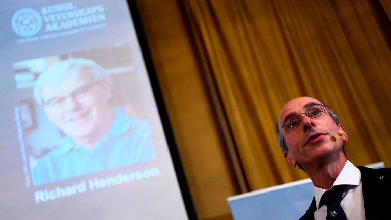 Member of the Nobel Committee for Chemistry Peter Brezezinski, right, presents the work of British scientist Richard Henderson