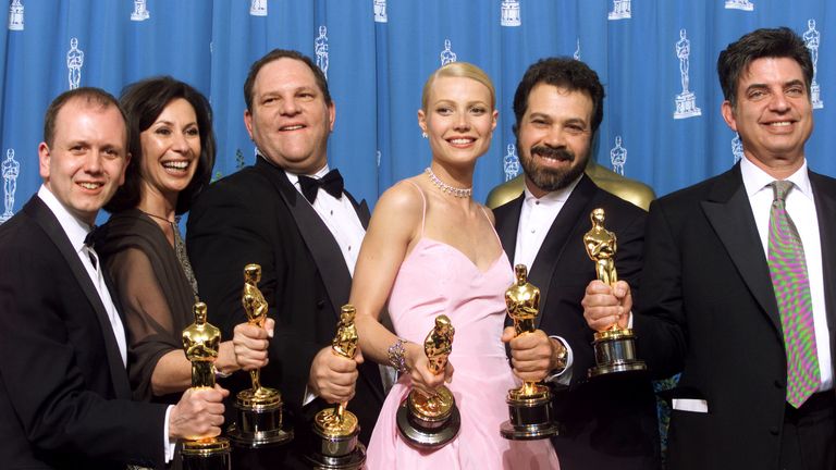 Gwyneth Paltrow celebrates the Oscar she won for Shakespeare in Love with the producers of the film, including Harvey Weinstein (3rd left)
