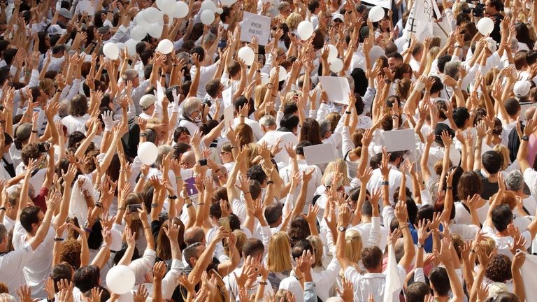 People attend a demonstration in favour of dialogue in a square in Barcelona, Spain