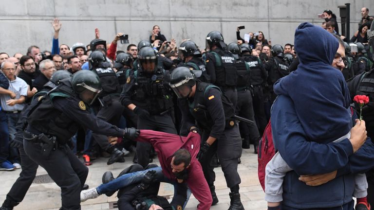 A man struggles with the police in Sany Julia de Ramis, near Girona