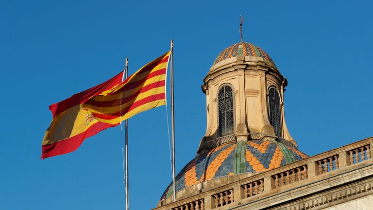 Spanish (L) and Catalan flags flutters atop the Generalitat Palace, the Catalan regional government headquarter in Barcelona, Spain, October 30, 2017. REUTERS/Yves Herman