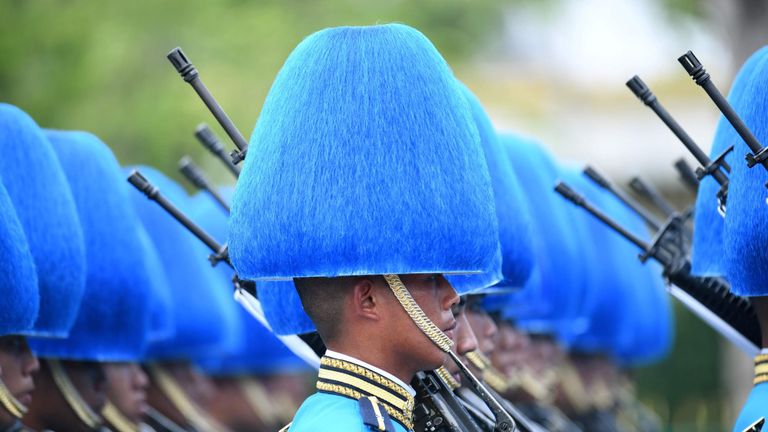 Military personnel take part in the funeral procession