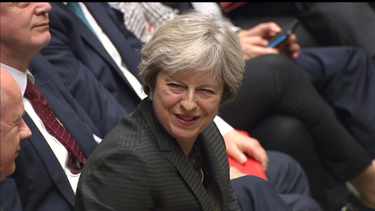 Theresa May sees the lighter side of an exchange in the House of Commons