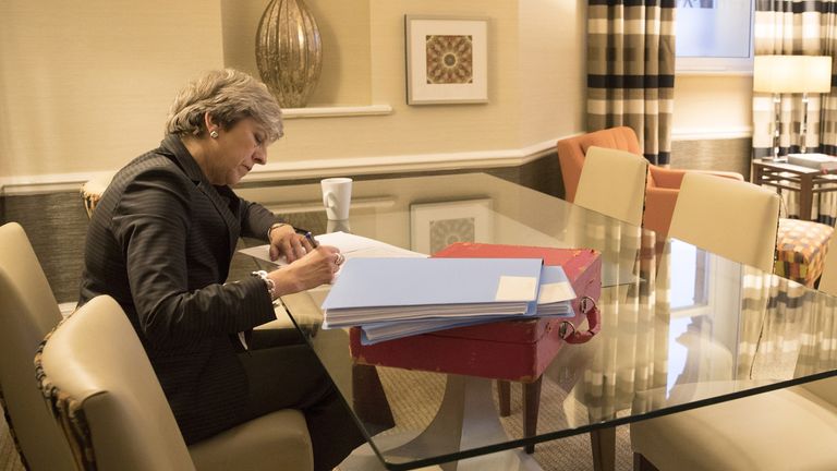Theresa May works on her conference speech in Manchester on Tuesday night