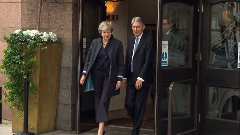 Theresa May and Philip Hammond leave hotel