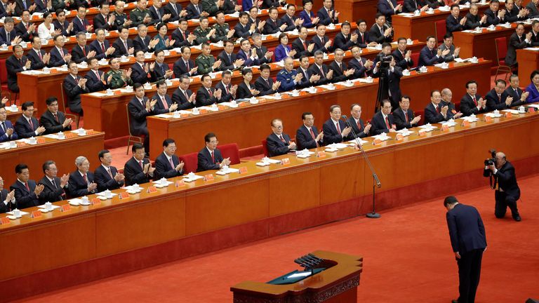 Chinese President Xi Jinping bows before delivering his speech