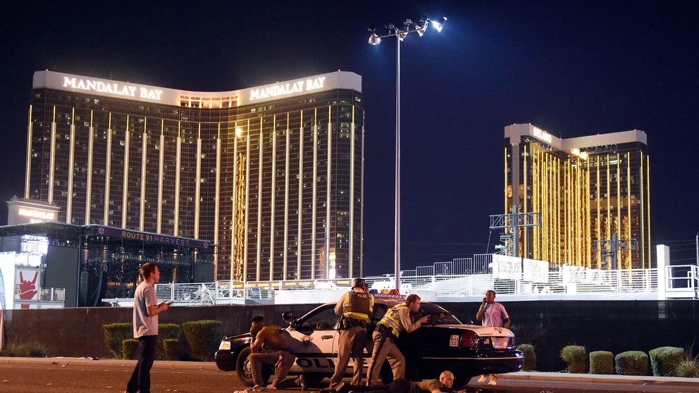 Las Vegas police stand guard along the streets outside the festival grounds of the Route 91 Harvest 