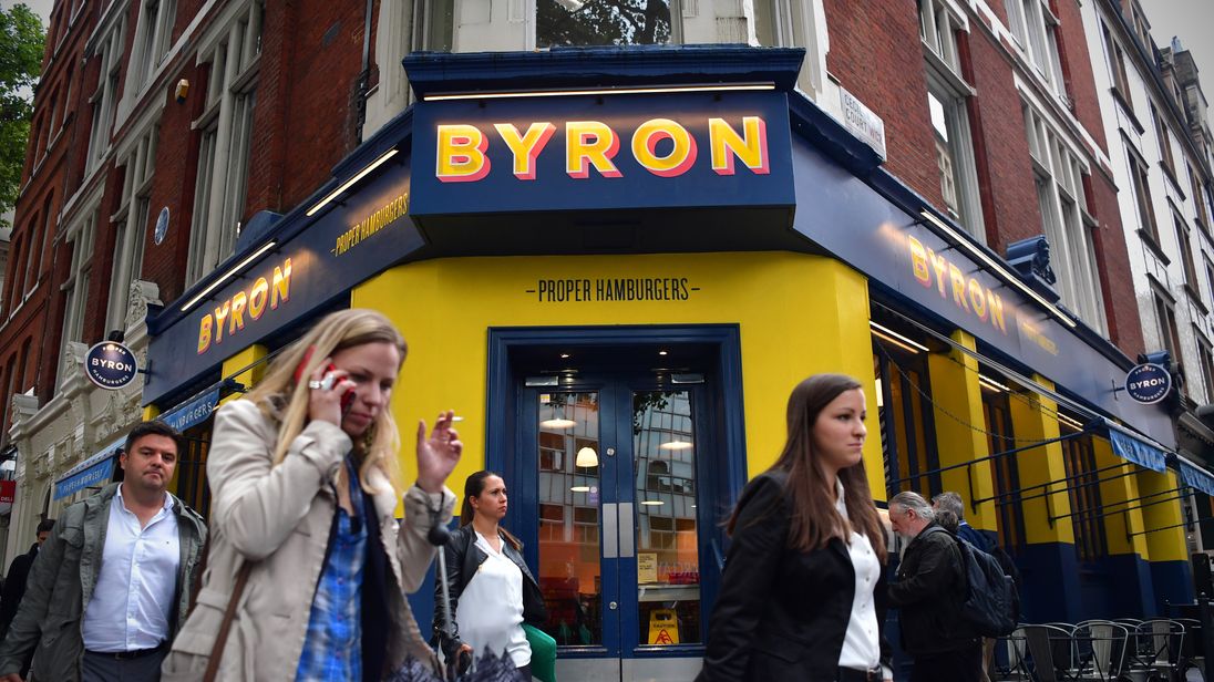 LONDON, ENGLAND - AUGUST 02: People walk past a Byron burger restaurant on August 2, 2016 in London, England. The British restaurant chain are alleged to have organised a training day for foreign staff in the capital, who were later arrested and deported by government authorities. (Photo by Carl Court/Getty Images)