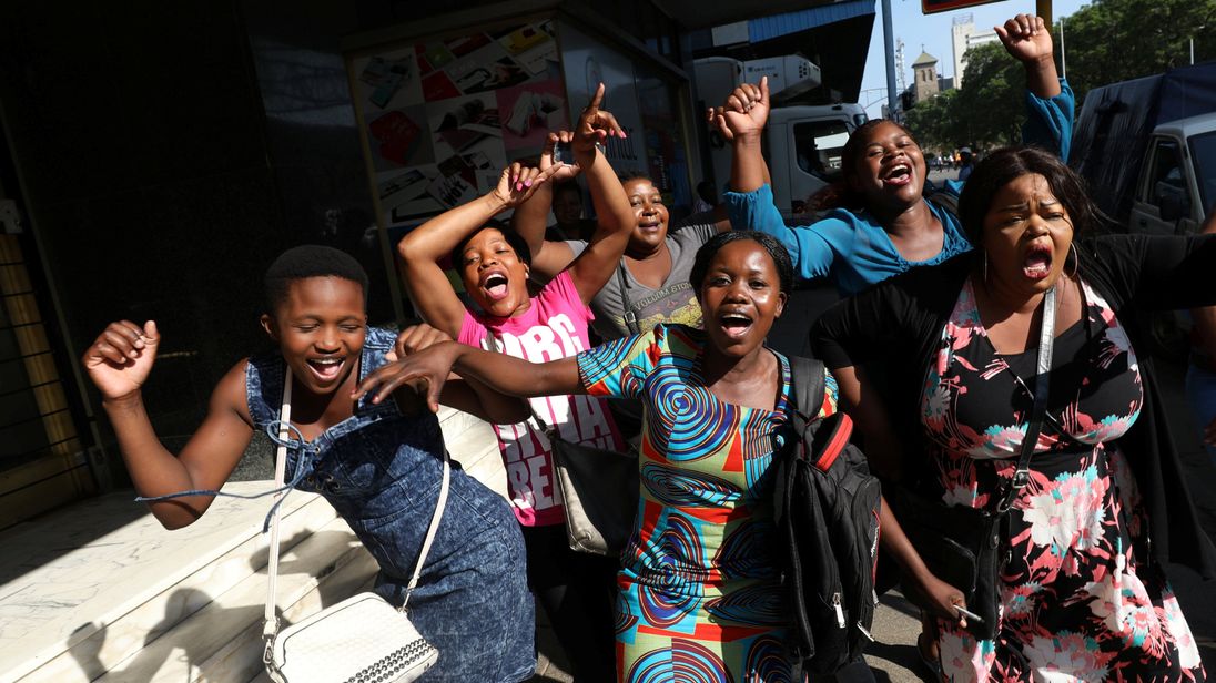 Zimbabweans celebrate in the morning sun after President Robert Mugabe resigned in Harare