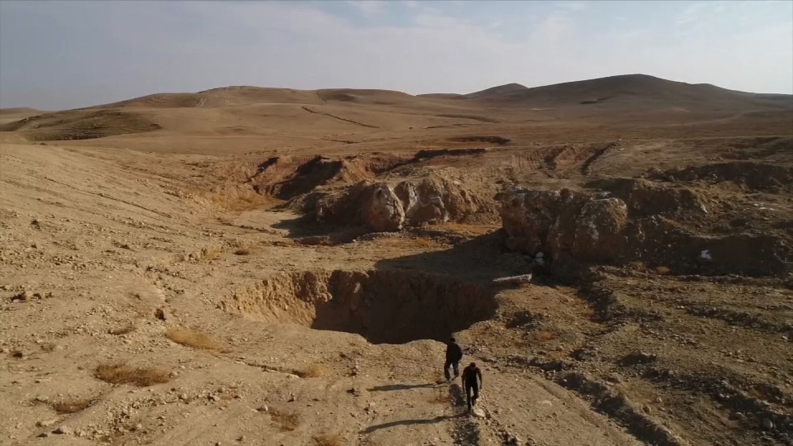Drone footage shows sinkhole that became Islamic State mass grave
