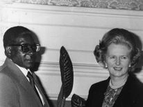Mr Mugabe shakes hands with then prime minister Margaret Thatcher in 1980