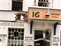 1986: Mugabe leaves the scene of the African National Congress (ANC) offices that were bombed days earlier by a South African commando