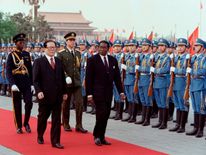 Chinese President Jiang Zemin (L) welcomes Robert Mugabe (R) with a Chinese honour guard during a welcoming ceremony outside the Great Hall of the People on 7 May 1993 in Beijing