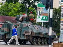 An armoured personnel carrier stationed by an intersection as Zimbabwean soldiers regulate traffic in Harare