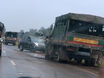Soldiers stand beside military vehicles just outside Harare