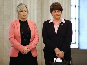 BELFAST, NORTHERN IRELAND - MARCH 22: Sinn Fein leader Michelle O&#39;Neill (L) and (DUP) Democratic Union Party Leader Arlene Foster wait to sign a book of condolence at Stormont on March 22, 2017 in Belfast, Northern Ireland. Northern Ireland&#39;s Former Deputy First Minister Martin McGuinness died overnight on Monday 20th March 2017. 