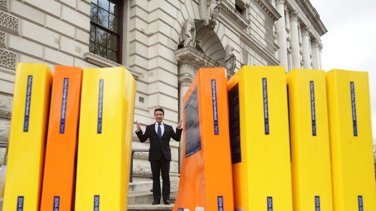ICAS Chief Executive Anton Colella with the books which comprise the UK tax code - which contain and up to 20,000 pages - outside the Treasury, in London, to call for simplification of the UK Tax Code. PRESS ASSOCIATION Photo. Picture date: Wednesday March 25, 2015. Photo credit should read: Yui Mok/PA Wire 