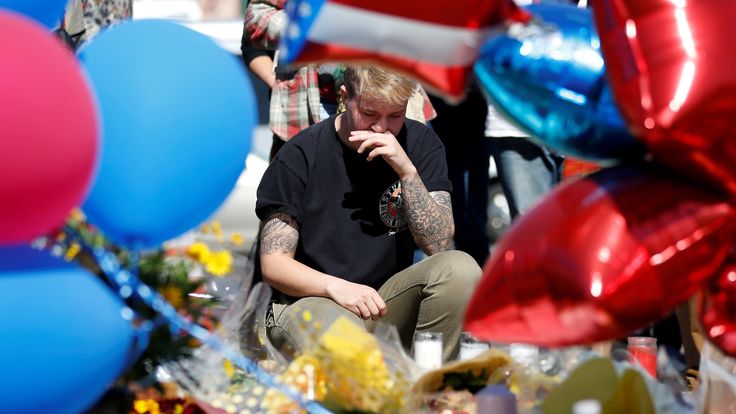 Bry Thompson wipes away tears at a makeshift memorial in the middle of Las Vegas Boulevard following the mass shooting in Las Vegas, Nevada, U.S., October 4, 2017