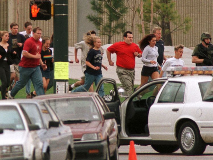 People flee from Columbine High School during the mass shooting